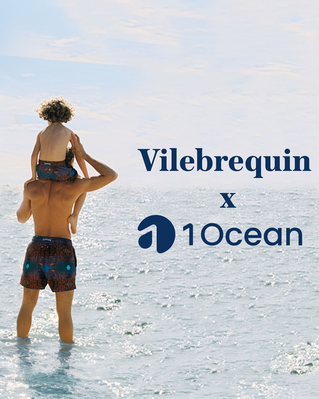 A boy on his father's shoulders, both of them facing away, looking at the ocean